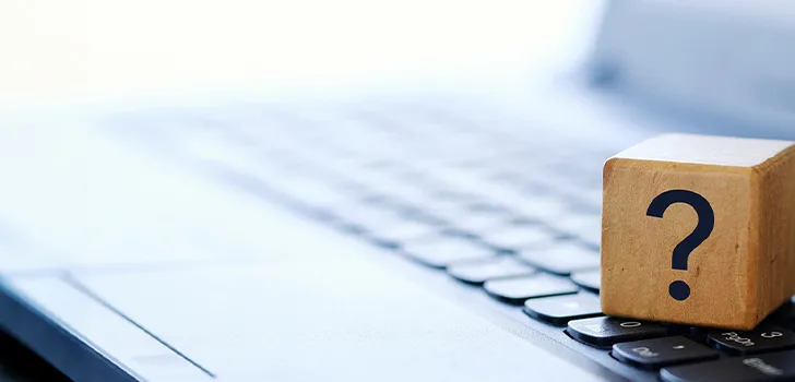 A wooden block with a question mark, representing a prompt for questions or exploration.